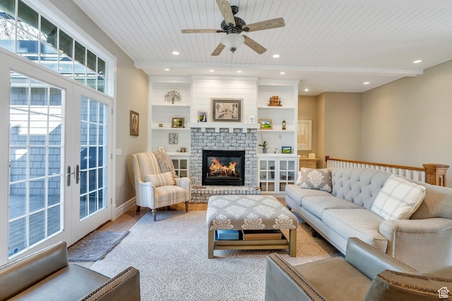 living area with wood finished floors, recessed lighting, ceiling fan, wood ceiling, and a brick fireplace