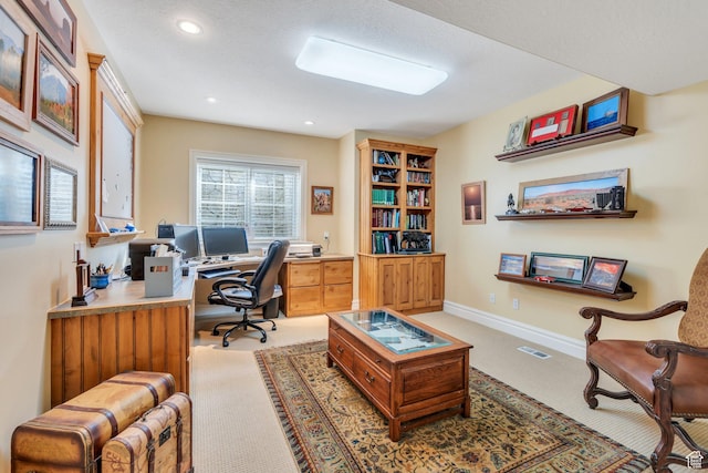 home office with recessed lighting, visible vents, light colored carpet, and baseboards