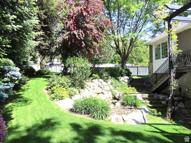 view of yard with stairs and fence
