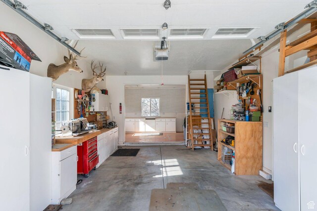 garage with a workshop area and a garage door opener