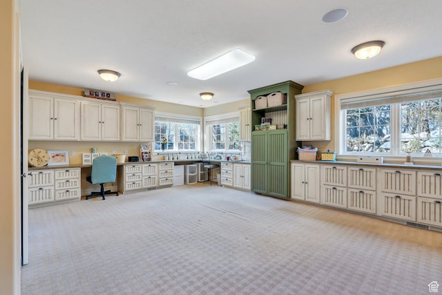 kitchen with open shelves, light carpet, and built in study area