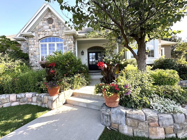 property entrance with french doors and stone siding