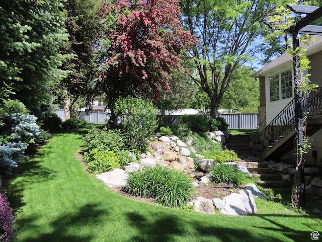 view of yard with stairway and fence