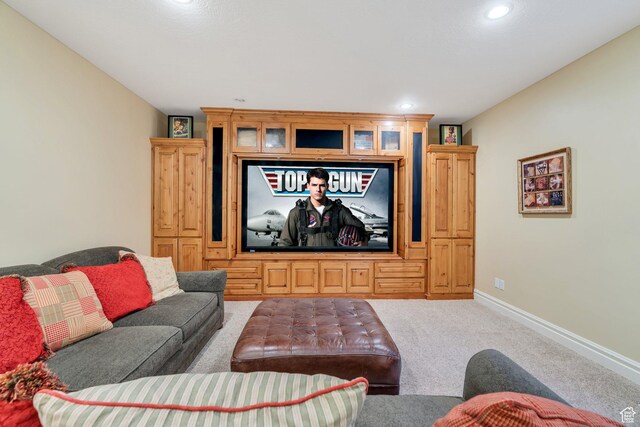 carpeted living area featuring recessed lighting and baseboards