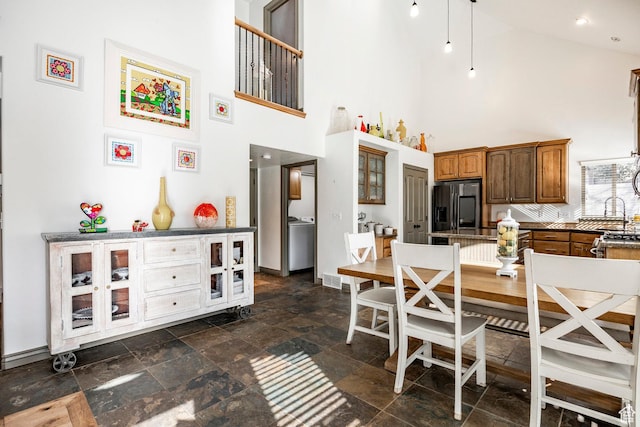 2652 E 6500 S, Uintah, UT 84403 - dining space with a towering ceiling, stone tile flooring, baseboards, and washer / clothes dryer