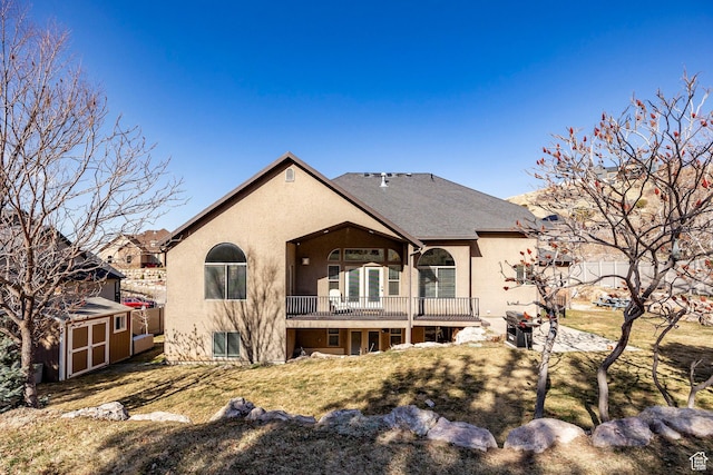2652 E 6500 S, Uintah, UT 84403 - back of property with a storage shed, stucco siding, an outbuilding, a balcony, and a lawn