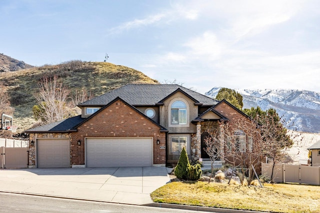 2652 E 6500 S, Uintah, UT 84403 - traditional-style home with a mountain view, an attached garage, and a gate