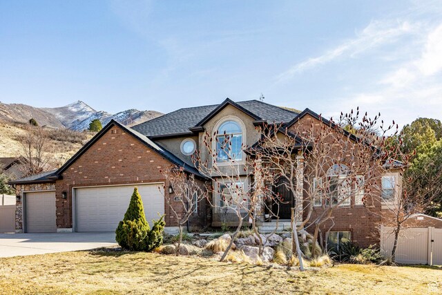 2652 E 6500 S, Uintah, UT 84403 - view of front of property with a garage, brick siding, driveway, and fence