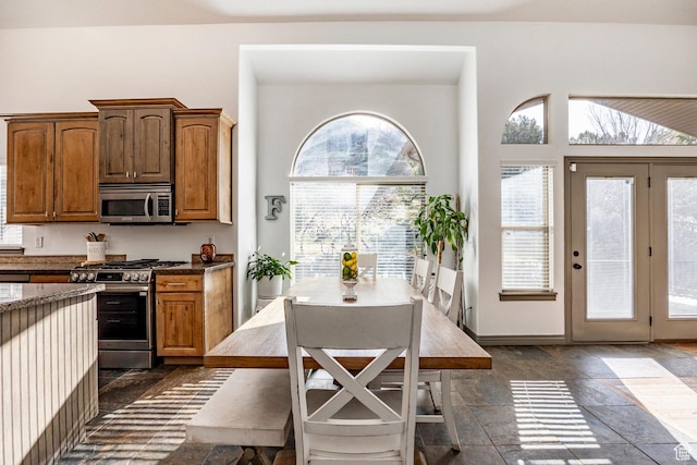 2652 E 6500 S, Uintah, UT 84403 - kitchen with appliances with stainless steel finishes, healthy amount of natural light, stone tile flooring, and dark stone countertops