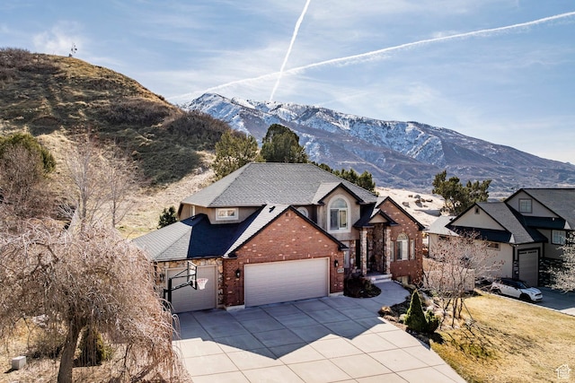 2652 E 6500 S, Uintah, UT 84403 - view of front of property with brick siding, an attached garage, concrete driveway, and a mountain view