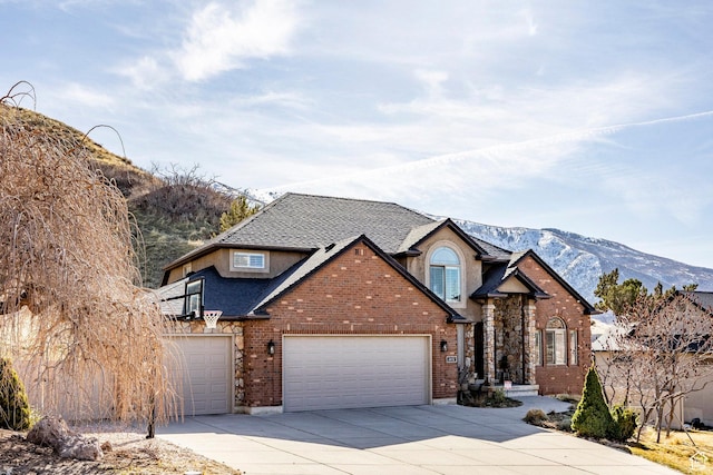 2652 E 6500 S, Uintah, UT 84403 - traditional-style house with concrete driveway, an attached garage, brick siding, a mountain view, and roof with shingles