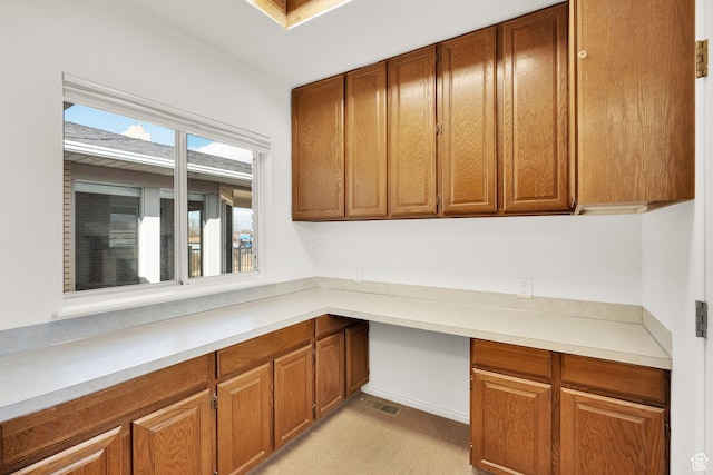 unfurnished office with visible vents and built in desk