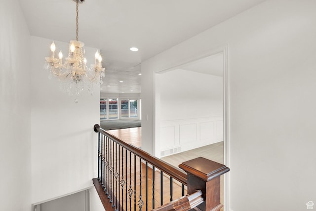 stairway featuring a notable chandelier, recessed lighting, and visible vents