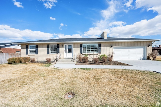single story home with a front lawn, driveway, fence, a garage, and brick siding