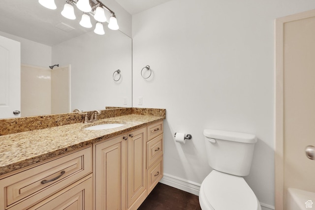 bathroom with walk in shower, baseboards, toilet, a notable chandelier, and vanity