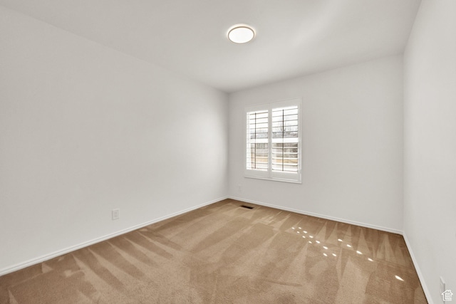 unfurnished room featuring visible vents, baseboards, and carpet floors