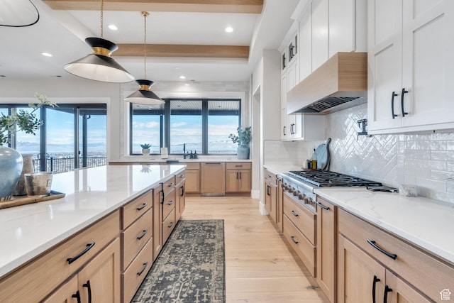 1413 N 1500 E, Provo, UT 84604 - kitchen with backsplash, light stone countertops, stainless steel gas cooktop, light wood-style floors, and custom exhaust hood