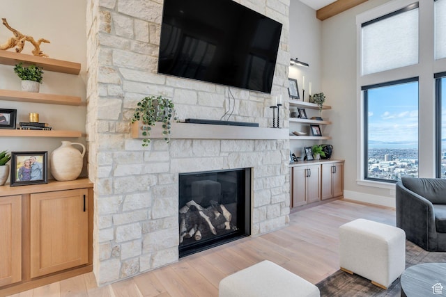 1413 N 1500 E, Provo, UT 84604 - living area with a stone fireplace, baseboards, and light wood-style floors