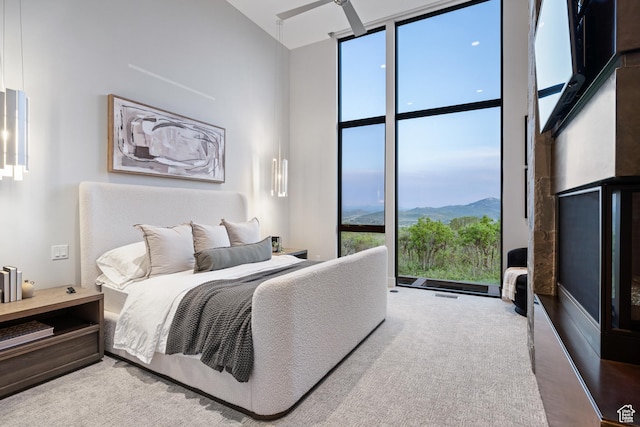 9774 N Red Hawk Trl, Park City, UT 84098 - bedroom featuring expansive windows, a towering ceiling, a mountain view, and carpet flooring