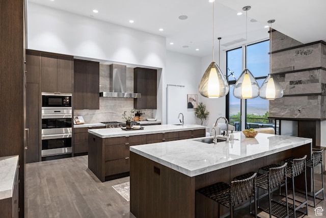 9774 N Red Hawk Trl, Park City, UT 84098 - kitchen with a sink, a spacious island, modern cabinets, stainless steel appliances, and wall chimney range hood