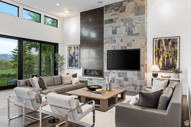 9774 N Red Hawk Trl, Park City, UT 84098 - living room featuring a towering ceiling, a high end fireplace, and wood finished floors
