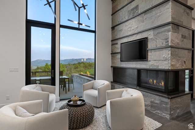 9774 N Red Hawk Trl, Park City, UT 84098 - living room with a stone fireplace, a high ceiling, and floor to ceiling windows