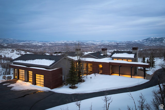 9774 N Red Hawk Trl, Park City, UT 84098 - exterior space featuring a garage, a mountain view, and a chimney
