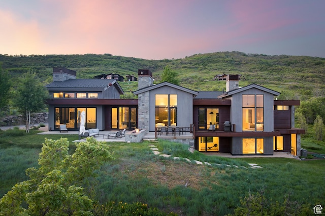 9774 N Red Hawk Trl, Park City, UT 84098 - rear view of house featuring a chimney, a patio, and a yard