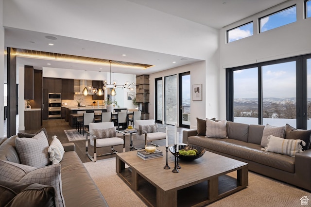 9774 N Red Hawk Trl, Park City, UT 84098 - living area featuring a chandelier, recessed lighting, a high ceiling, and a water view