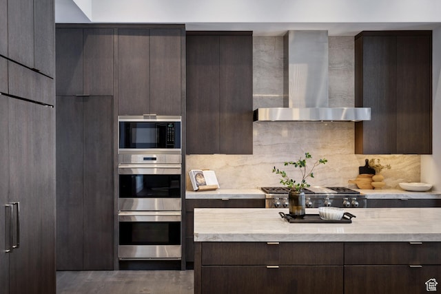 9774 N Red Hawk Trl, Park City, UT 84098 - kitchen with dark brown cabinetry, light countertops, stainless steel appliances, modern cabinets, and wall chimney exhaust hood