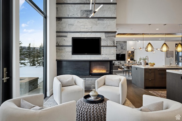 9774 N Red Hawk Trl, Park City, UT 84098 - living room with a fireplace, wood finished floors, a healthy amount of sunlight, and expansive windows