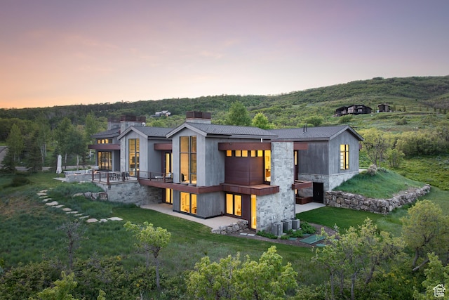 9774 N Red Hawk Trl, Park City, UT 84098 - back of house featuring a yard, stone siding, and a forest view