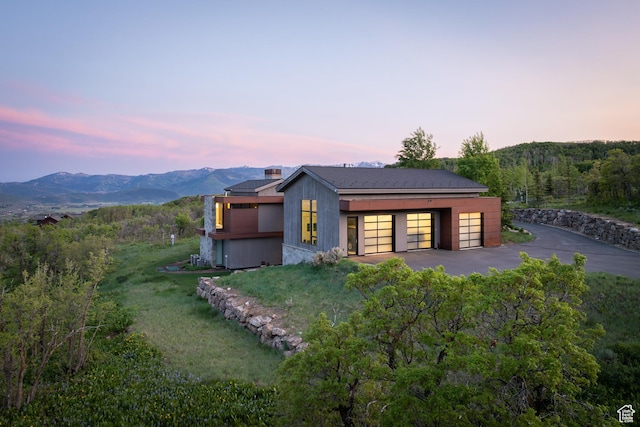 9774 N Red Hawk Trl, Park City, UT 84098 - view of front of house featuring a garage, a mountain view, and a front yard