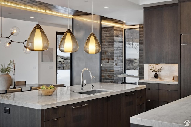 9774 N Red Hawk Trl, Park City, UT 84098 - kitchen with dark brown cabinetry, light stone counters, modern cabinets, and a sink