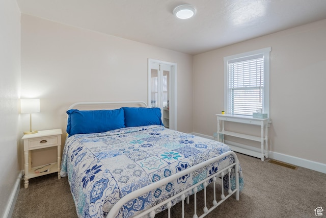 carpeted bedroom with visible vents and baseboards