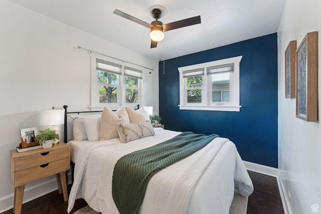 bedroom featuring baseboards, ceiling fan, and wood finished floors