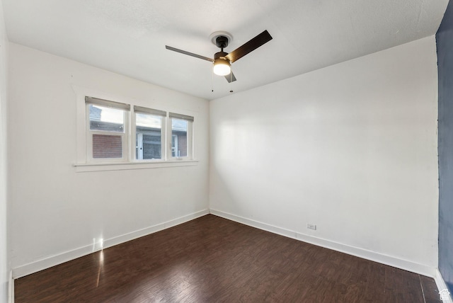 unfurnished room with baseboards, ceiling fan, and dark wood-style flooring
