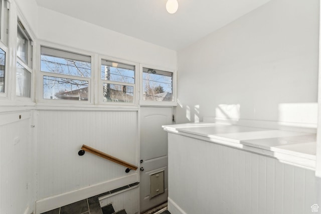 laundry area with baseboards and a healthy amount of sunlight