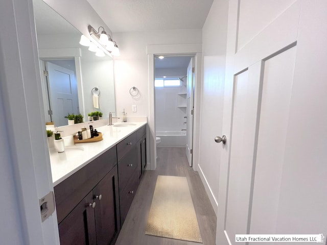 2245 S Beachcomber Ln, Garden City, UT 84028 - full bath with toilet, a sink, shower / washtub combination, wood finished floors, and double vanity