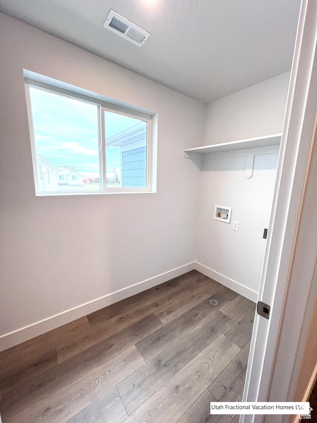 2245 S Beachcomber Ln, Garden City, UT 84028 - laundry area featuring visible vents, washer hookup, wood finished floors, baseboards, and laundry area