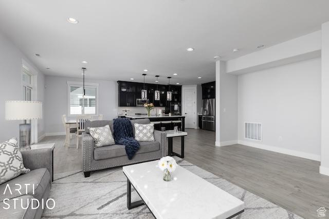 2211 W Parkview Dr, Syracuse, UT 84075 - living area with recessed lighting, visible vents, baseboards, and light wood-style floors