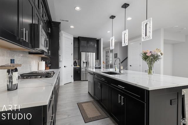 2211 W Parkview Dr, Syracuse, UT 84075 - kitchen featuring tasteful backsplash, a sink, appliances with stainless steel finishes, and dark cabinets