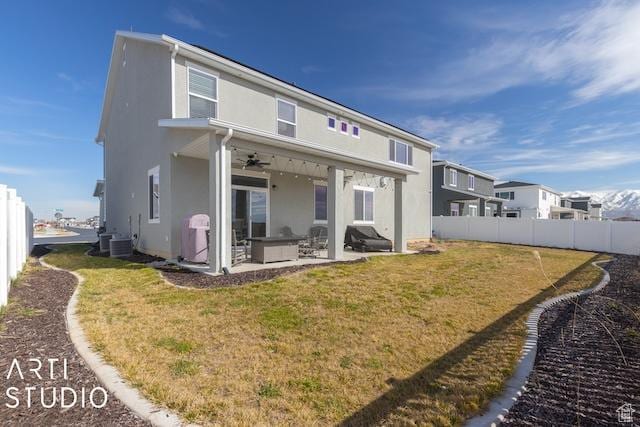 2211 W Parkview Dr, Syracuse, UT 84075 - back of property featuring ceiling fan, stucco siding, a lawn, a fenced backyard, and a patio