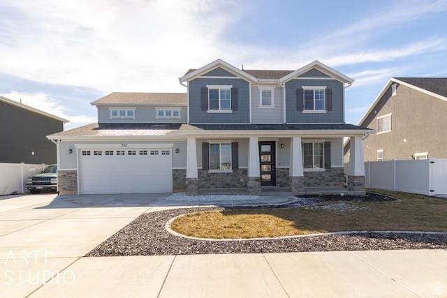 2211 W Parkview Dr, Syracuse, UT 84075 - craftsman house featuring concrete driveway, fence, and stone siding