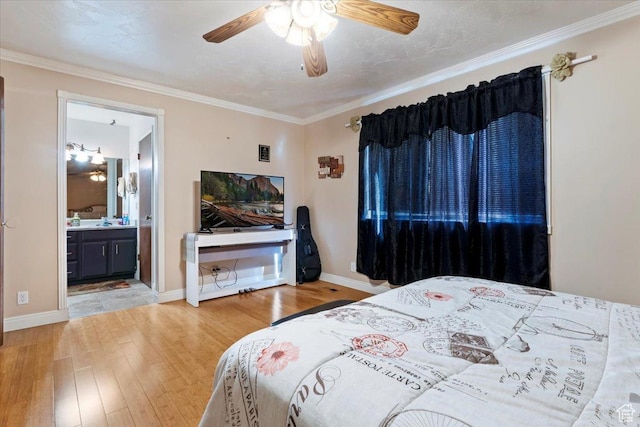 bedroom featuring baseboards, ensuite bath, wood finished floors, and ornamental molding