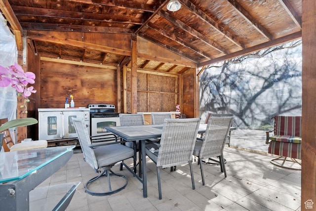 view of patio / terrace featuring outdoor dining space and washer / dryer
