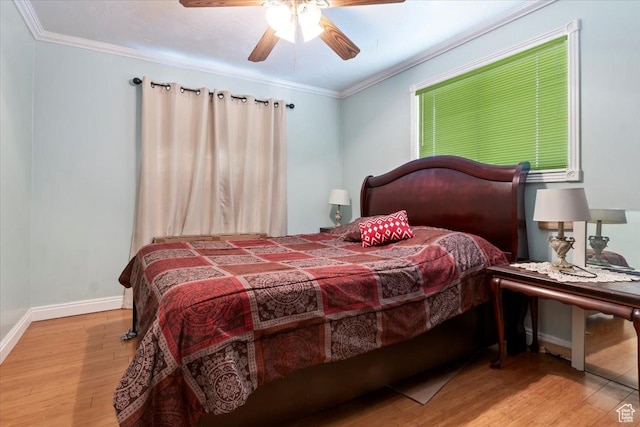 bedroom featuring ceiling fan, wood finished floors, baseboards, and ornamental molding