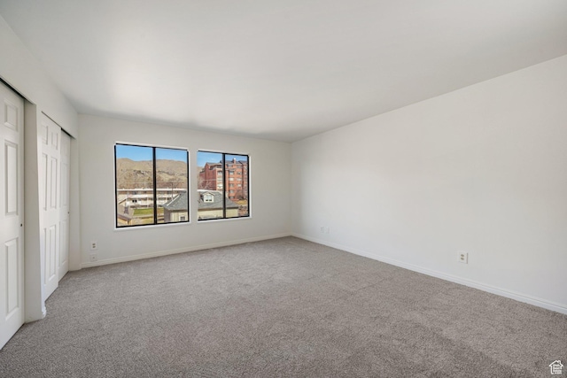 123 E 2nd Ave N Unit T-9, Salt Lake City, UT 84103 - unfurnished bedroom featuring light carpet, two closets, and baseboards