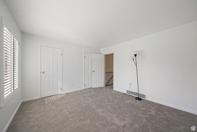 123 E 2nd Ave N Unit T-9, Salt Lake City, UT 84103 - unfurnished bedroom featuring visible vents, baseboards, and carpet
