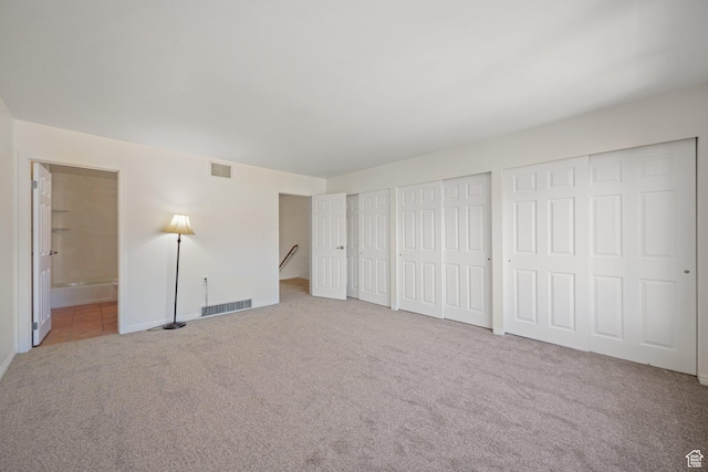 123 E 2nd Ave N Unit T-9, Salt Lake City, UT 84103 - unfurnished bedroom featuring carpet flooring, visible vents, connected bathroom, and multiple closets